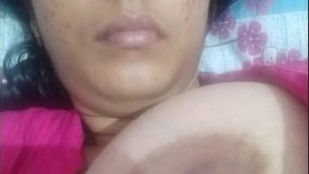 A sultry Desi woman entices with her ample breasts and intimate area