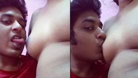 A guy pleasuring his girlfriend's breasts