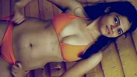 Indian girl in a yellow swimsuit displays her attractive physique