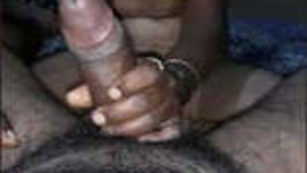 A thin Indian wife stimulates a large penis with her hands