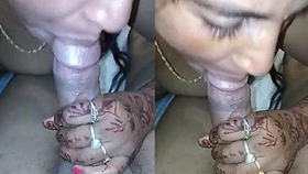 Indian woman with henna tattooed hands performs oral sex