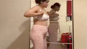 Pakistani milf strips down to a white bra and flashes her pantyless ass